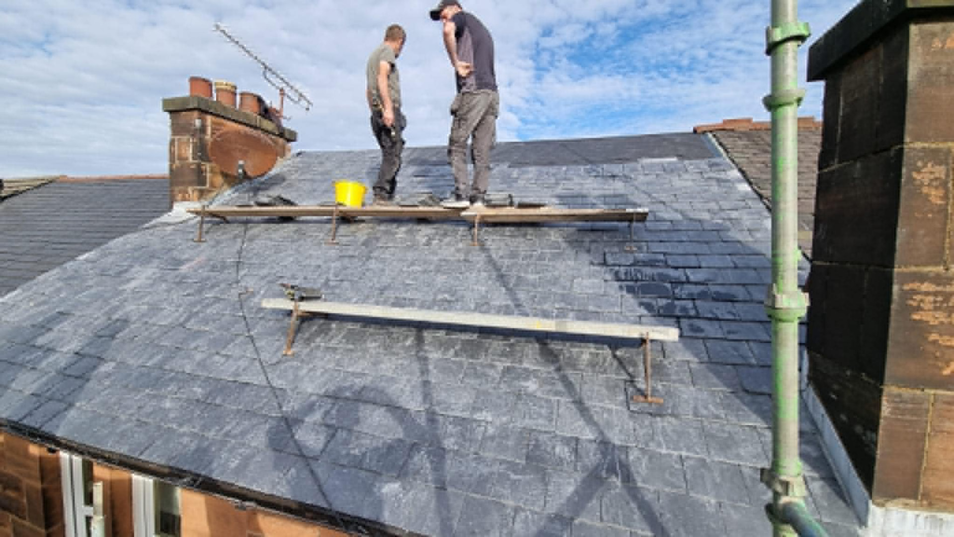 Roofers re-slating a traditional Glasgow tenement roof