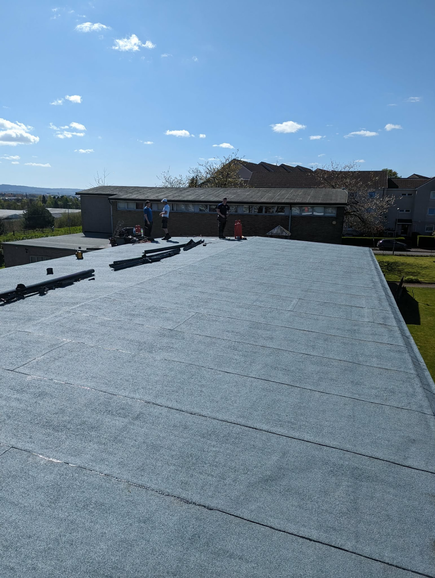 Scotsway Roofing team on a completed torch-on felt flat roof