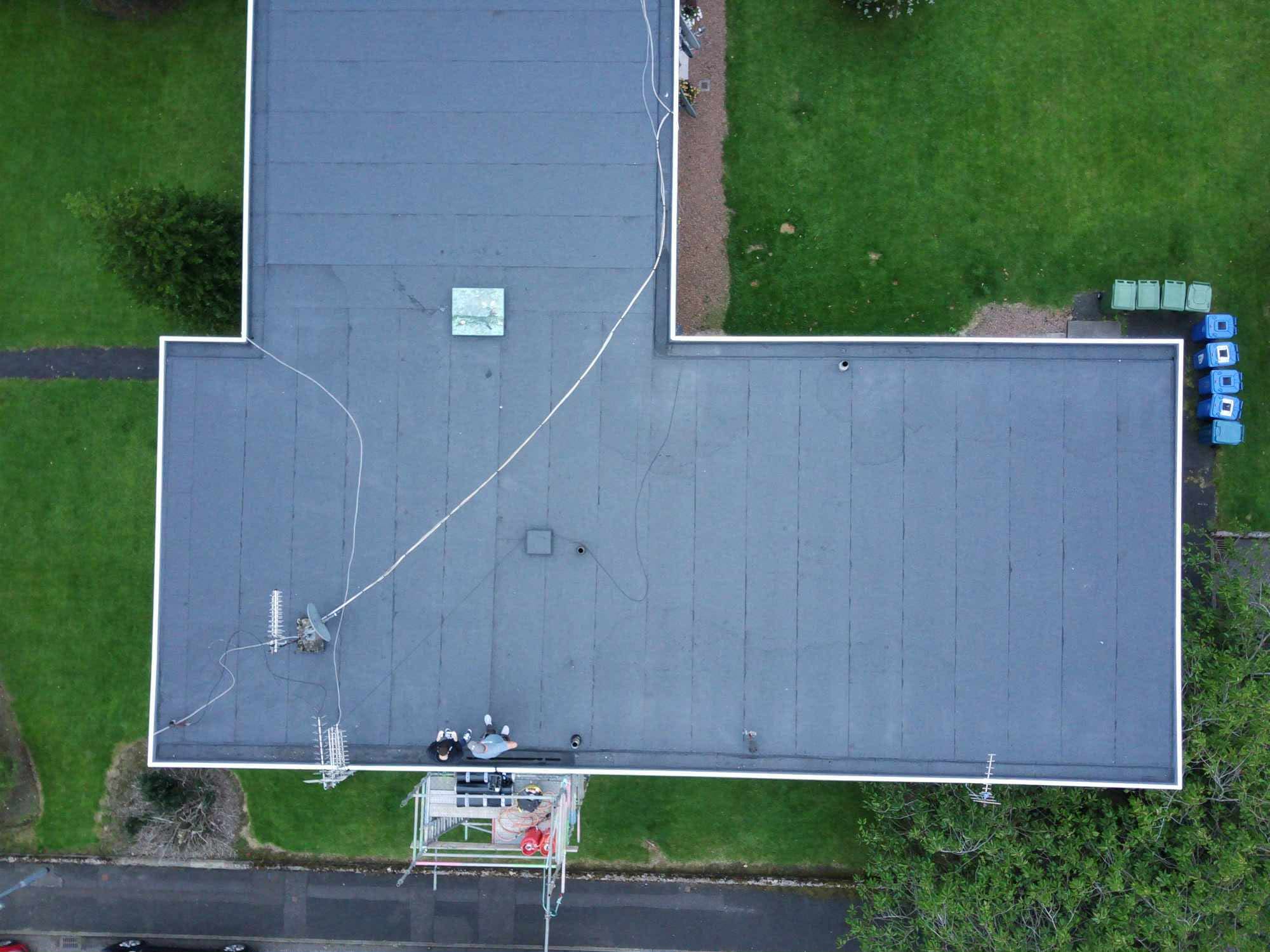 Drone view of a finished felt flat roof on a Glasgow block